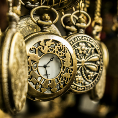 Close-up of ornate vintage pocket watches showcasing intricate designs and luxury aesthetics.